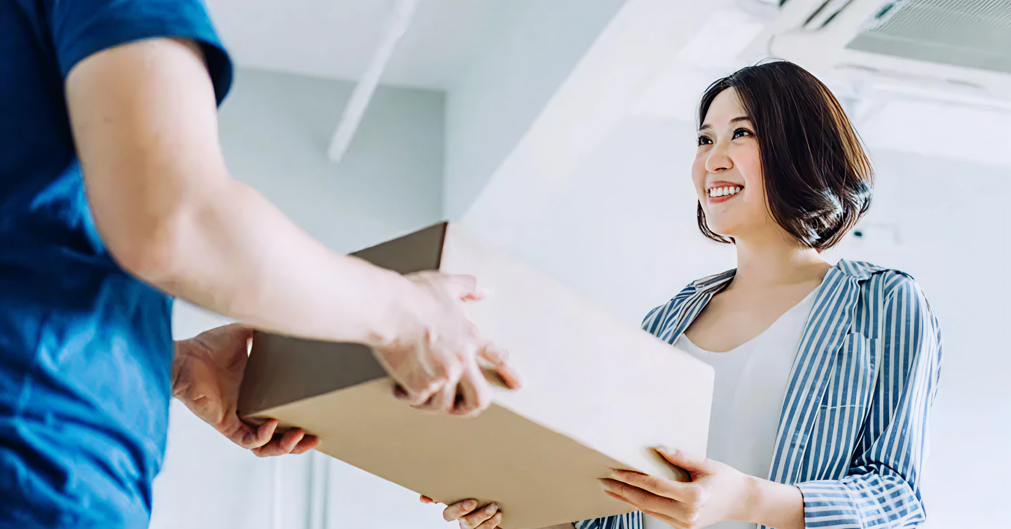 image of a woman taking a parcel from a courier, delivered by ParcelDaily, which uses respond.io to manage its customer communications